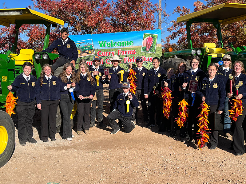 Group photo of FFA students with tractors