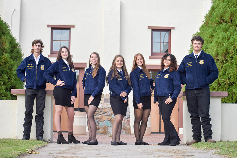 Seven FFA Officers posing for a picture outside
